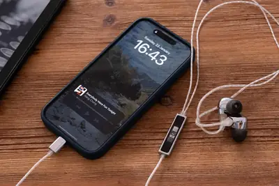Phone with earphones playing audio on the lock screen while the display stays off